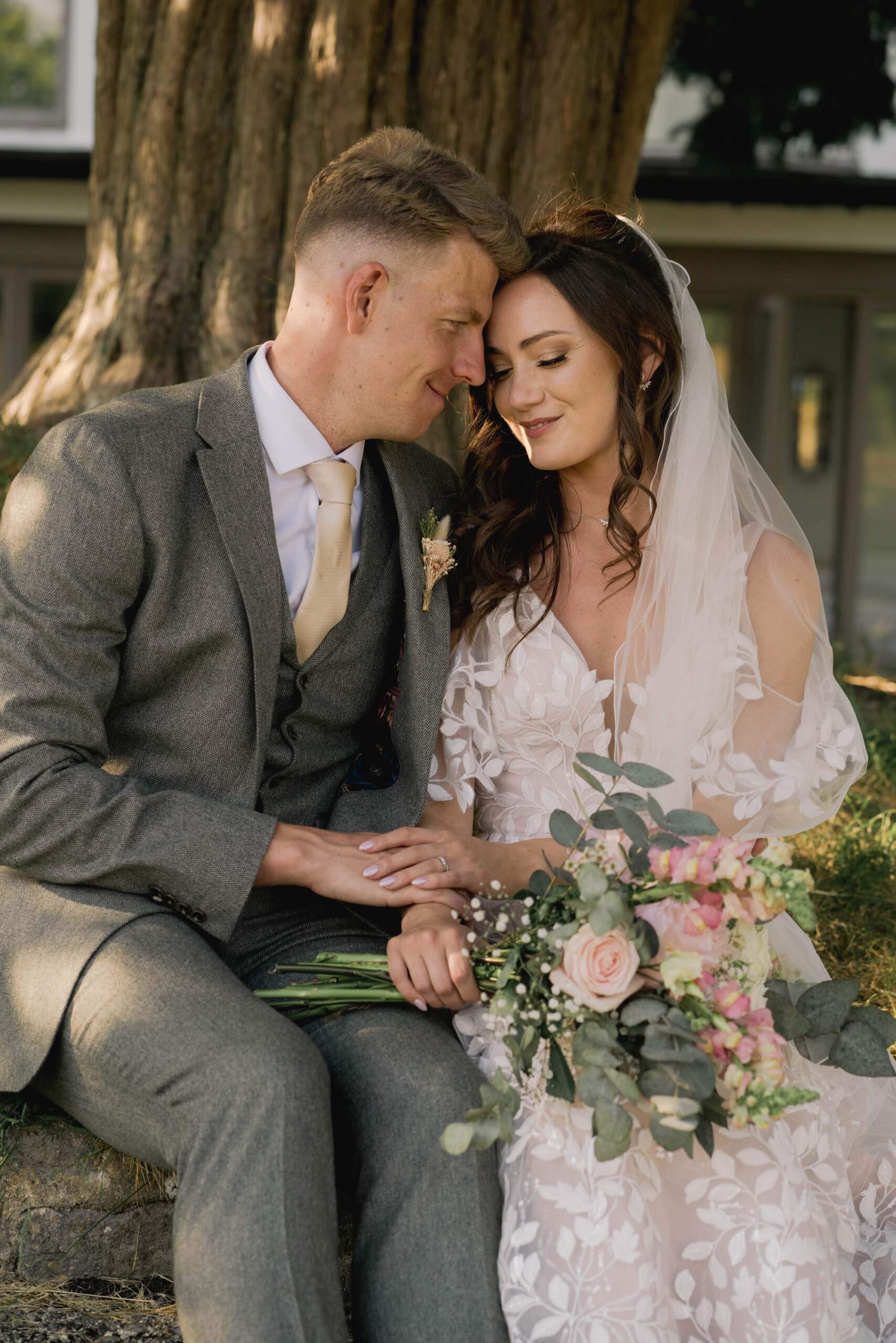 Bride and groom hug closely on their wedding day in West Sussex.