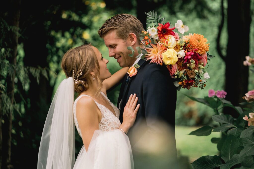 Bride and groom hug closely on their wedding day in Hertfordshire.